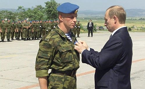 President Putin presenting government awards to Russian peacekeepers. Mr Putin handing the Order of Military Merit to Captain Konstantin Kharlamov.