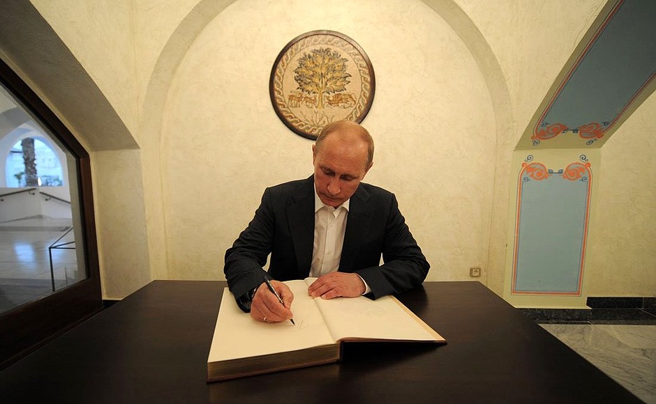 После церемонии открытия Странноприимного дома. Владимир Путин оставил запись в книге почётных гостей.