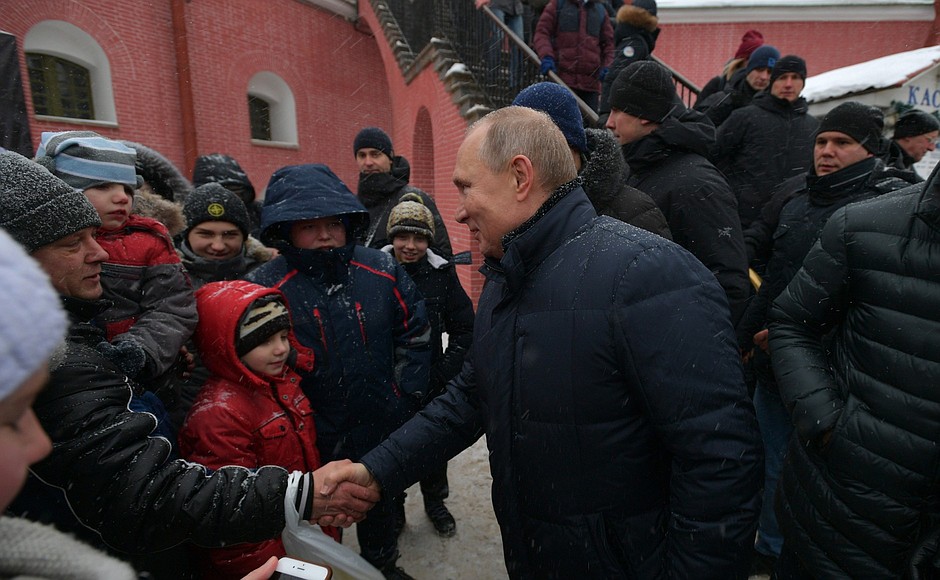 At Peter and Paul Fortress public festivities. Vladimir Putin is photographed with city residents and tourists.