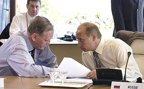 President Putin with Canadian Prime Minister Jean Chretien before the start of the final working meeting of the G8 heads of state and government. Background left: Russian President\'s Economic Adviser Andrei Illarionov.