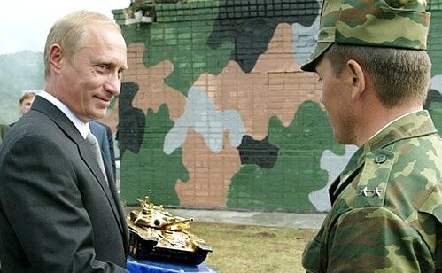President Putin receiving a gift of a souvenir replica of the T-90 tank at the Peschanka firing range of the 212th Training Centre, the Siberian Military District.
