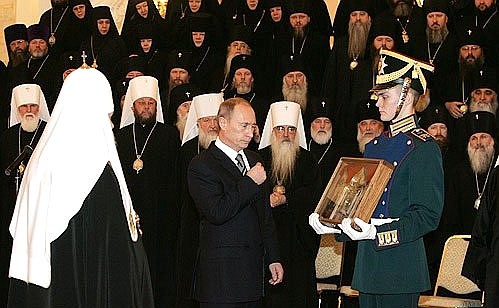 At a meeting with Russian Orthodox clergy to mark the ninetieth anniversary of the patriarchate\'s restoration. Presenting Patriarch of Moscow and All Russia Alexii II with a fragment of the Robe of Christ, one of the holy Christian relics from the Moscow Kremlin Museum\'s collection.
