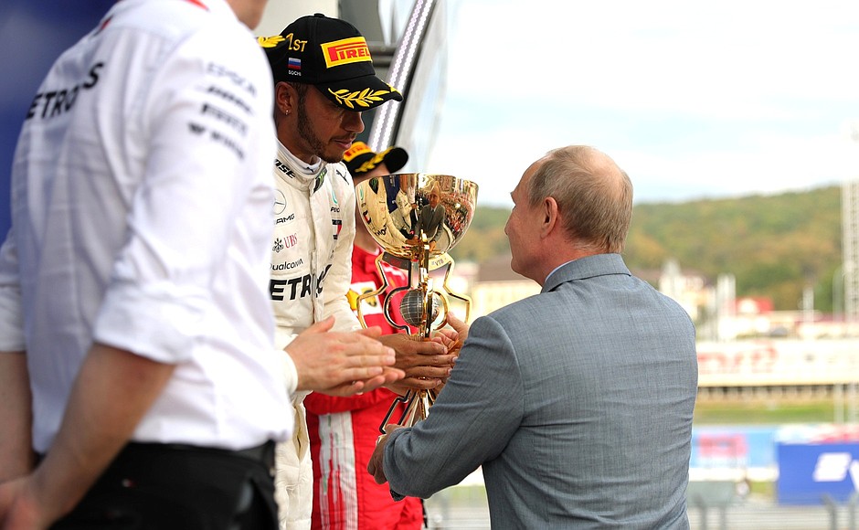 Vladimir Putin presents the cup to the winner of the Formula 1 Russian Grand Prix, British driver Lewis Hamilton.