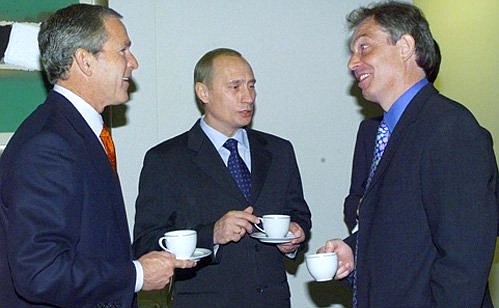 President Vladimir Putin with US President George Bush and British Prime Minister Tony Blair during a recess in the G8 leaders\' meeting.