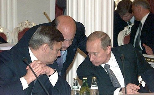 President Vladimir Putin with Russian Prime Minister Mikhail Kasyanov, to the left, and Foreign Minister Igor Ivanov during the first meeting of the Eurasian Economic Community.