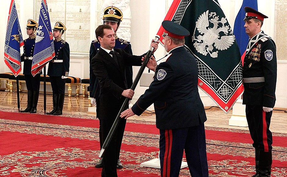 Presenting banners to Cossack military societies. Dmitry Medvedev presents the banner of Siberian Cossack military society to ataman Anatoly Ostryagin.