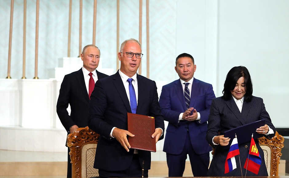 Signing documents following Russian-Mongolian talks.