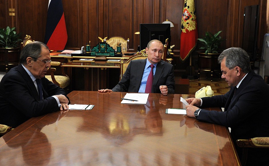 With Foreign Minister Sergei Lavrov (left) and Defence Minister Sergei Shoigu.
