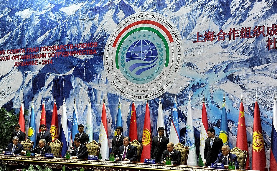 Signing documents following the summit of Shanghai Cooperation Organisation.