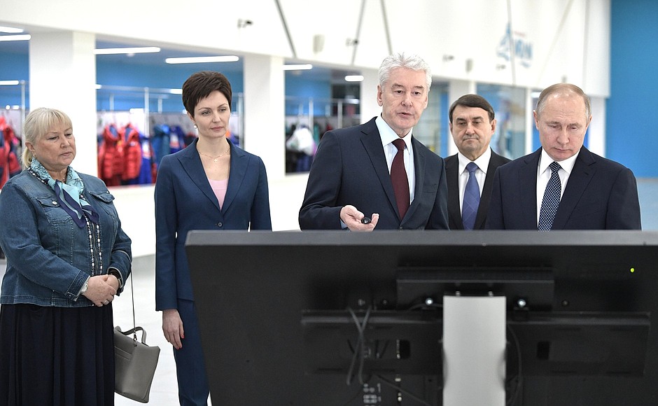 At the Olympic Synchronised Swimming Centre of Anastasia Davydova. Vladimir Putin and Moscow Mayor Sergei Sobyanin examine the information stand on the development of physical culture and sport in Moscow.