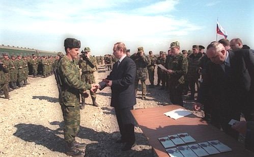 Presenting servicemen with orders and medals at a farewell ceremony for the 331st Airborne Regiment of the 98th Airborne Division.