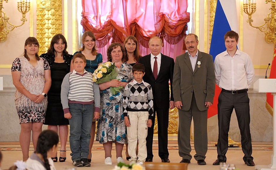 Presenting the Order of Parental Glory to Antonina and Ivan Ryabov, who are raising 13 children.