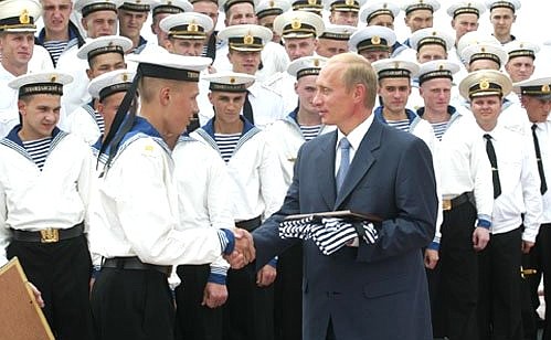 President Putin aboard the anti-submarine warfare (ASW) ship Admiral Shaposhnikov of the Russian Navy\'s Pacific Fleet. Sailors presenting souvenirs to President Putin.
