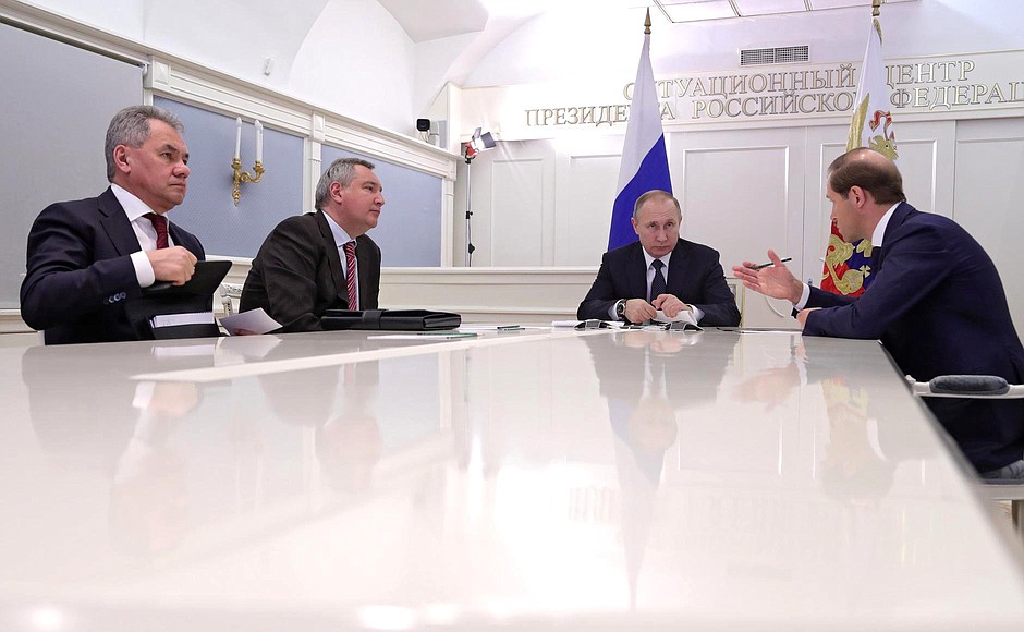 Videoconference with Russian Aircraft Corporation MiG. With Defence Minister Sergei Shoigu (left), Deputy Prime Minister Dmitry Rogozin and Industry and Trade Minister Denis Manturov (right).