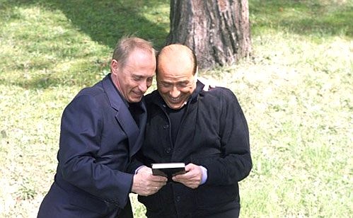 President Putin presenting the book The Silvio Berlsuconi Effect to Italian Prime Minister Silvio Berlusconi. The book is about Berlusconi\'s political career.