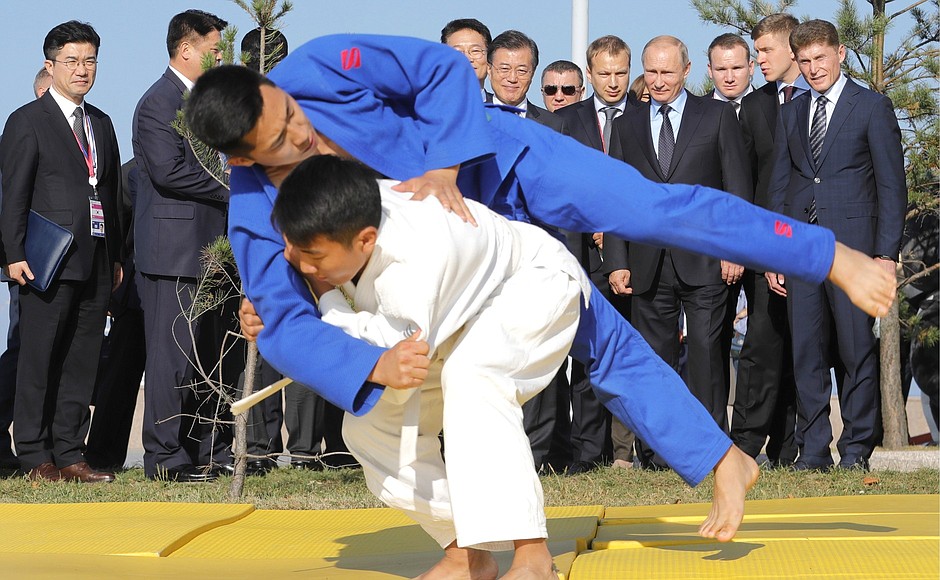 Vladimir Putin and President of the Republic of Korea Moon Jae-in watch a demonstration performance by a youth judo team from the Sakhalin Region.