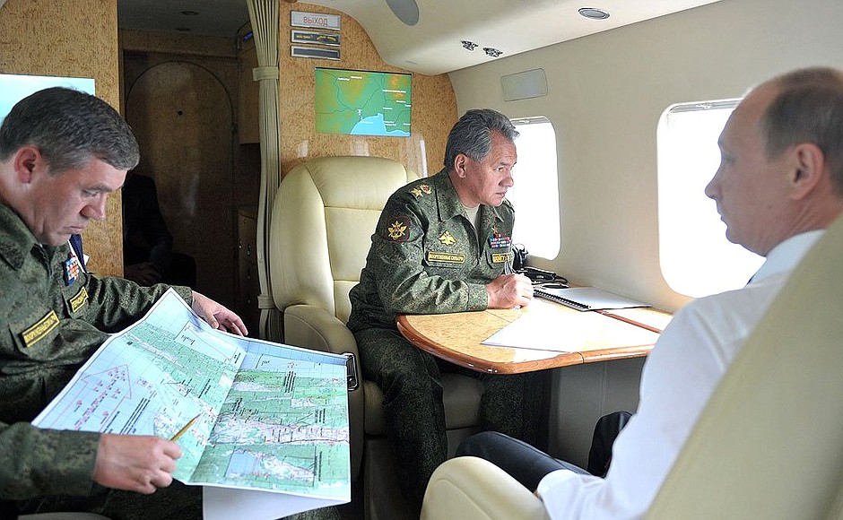 During the flight over the military exercises being held as part of the comprehensive troop inspection in the Eastern Military District. With Defence Minister Sergei Shoigu and Chief of the General Staff of the Russian Armed Forces Valery Gerasimov (left).