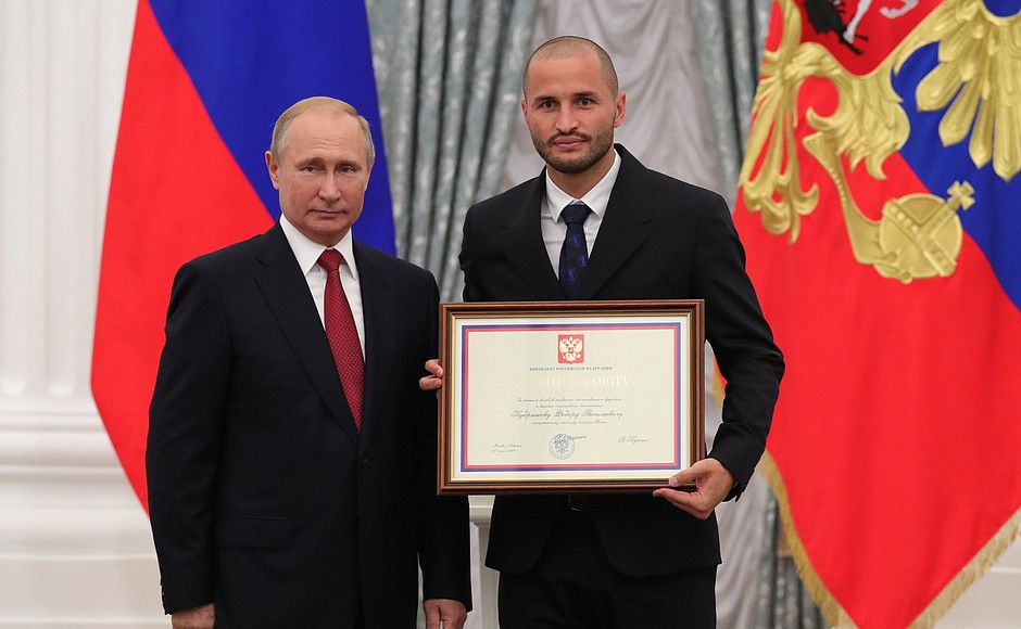 A letter of recognition for contribution to the development of Russia football and high athletic achievement is presented to Russia national football team player Fyodor Kudryashov.