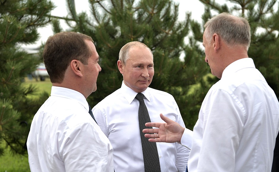 With Prime Minister Dmitry Medvedev (left) and Security Council Secretary Nikolai Patrushev during a visit to the VolleyGrad sports and fitness centre.