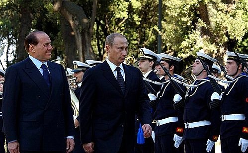 Italian Prime Minister Silvio Berlusconi greeting President Putin.