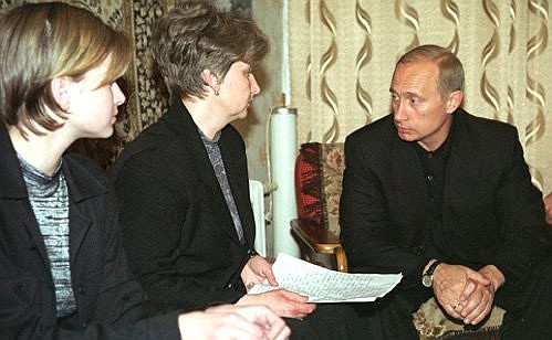 Vladimir Putin with Irina Lyachina, the widow of Gennady Lyachin, the commander of the Kursk nuclear submarine, and his daughter.