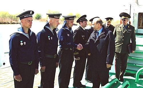 President Putin meeting border guards on a patrol boat.