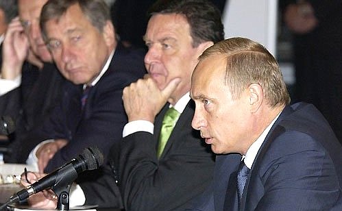 President Putin with German Chancellor Gerhard Schroeder at a meeting with Russian and German businessmen.