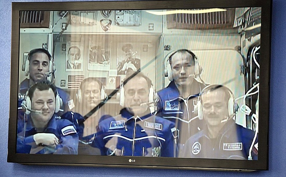 During a video linkup with the International Space Station. The ISS crew is visible on the screen.