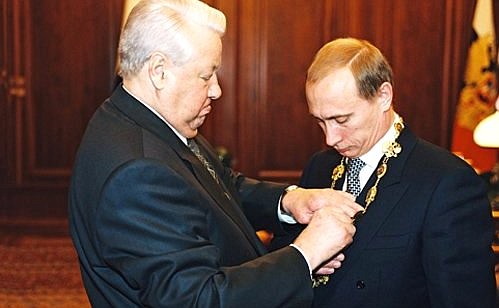 President Boris Yeltsin handing the Presidential Emblem to Vladimir Putin.