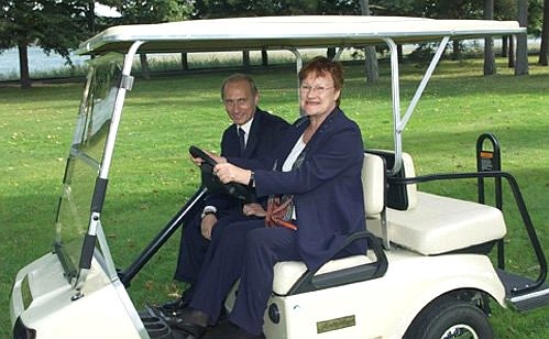 President Putin and President Tarja Halonen driving in an electric car.