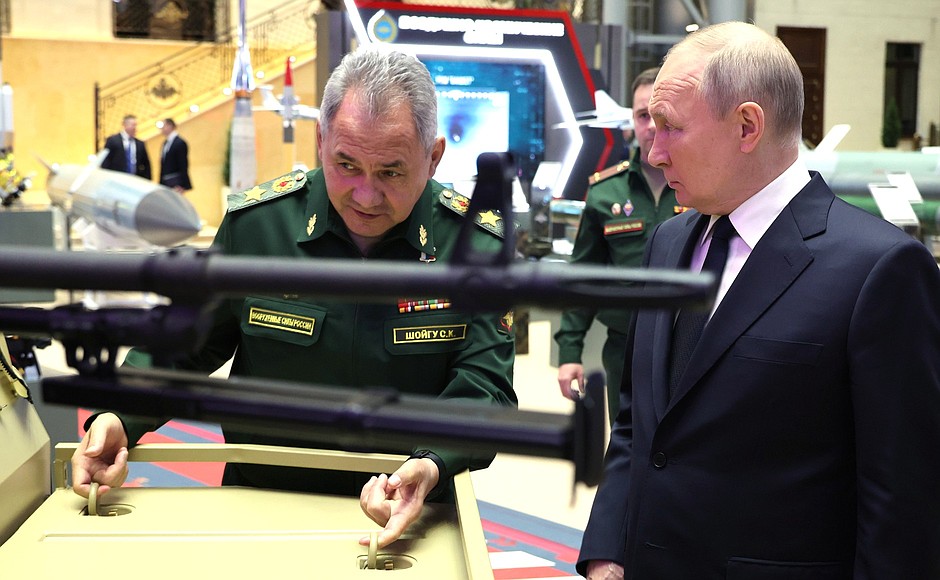 Touring the exhibition of modern military hardware at the National Defence Control Centre. With Defence Minister Sergei Shoigu.
