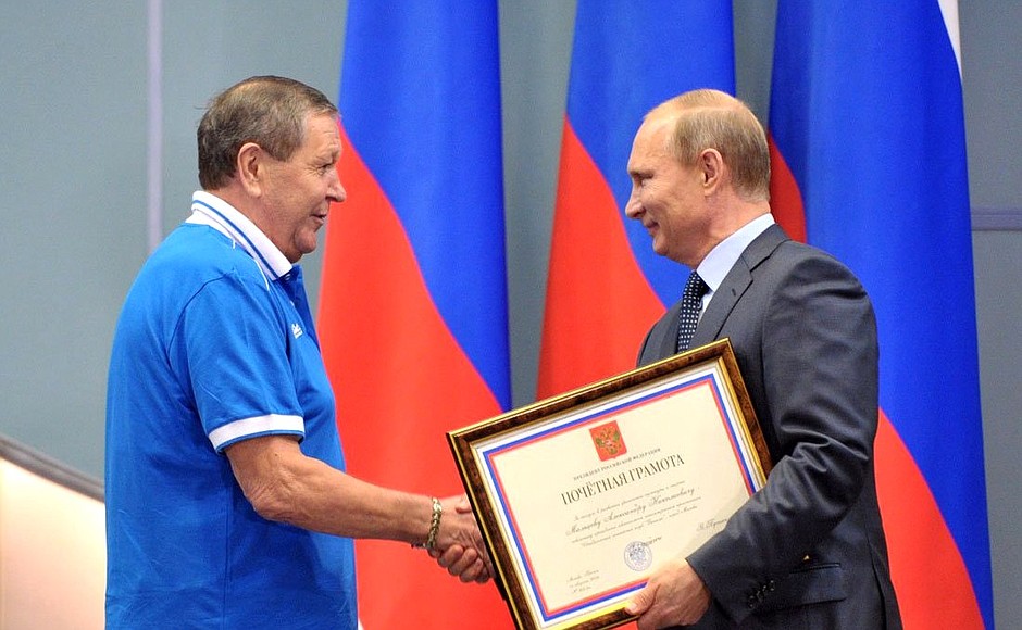 Vladimir Putin presents Alexander Maltsev with an honorary certificate for his services to developing physical culture and sport.