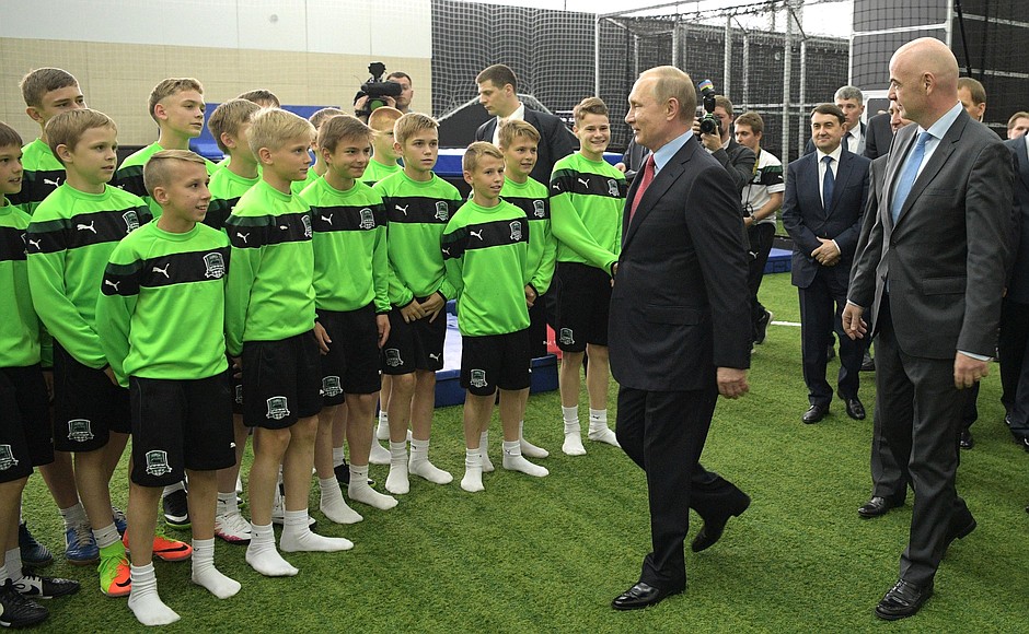 With students of the FC Krasnodar Academy. Right: FIFA President Gianni Infantino.