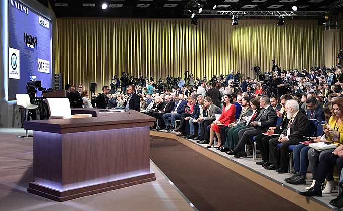 Before the beginning of Vladimir Putin’s annual news conference.