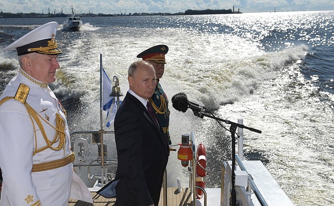 The Supreme Commander-in-Chief from a cutter reviewed fleet formations, lined up for the parade in the Kronstadt roadstead. With Defence Minister Sergei Shoigu (right) and Commander-in-Chief of the Russian Navy Nikolai Evmenov.