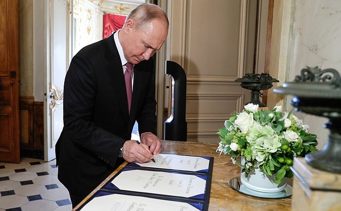 Following the meeting with President of Switzerland Guy Parmelin Vladimir Putin signed the distinguished visitors' book.