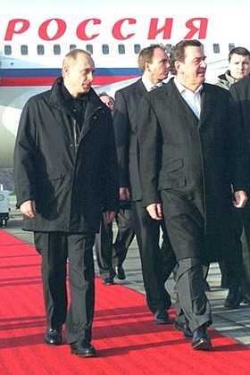 President Putin is welcomed at the airport by German Federal Chancellor Gerhard Schroeder.