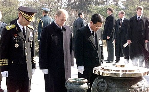 President Putin laying a wreath at the National Cemetery\'s eternal flame.