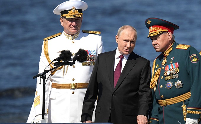 The Supreme Commander-in-Chief from a cutter reviewed fleet formations, lined up for the parade. With Defence Minister Sergei Shoigu and Commander-in-Chief of the Navy Nikolai Yevmenov (left).