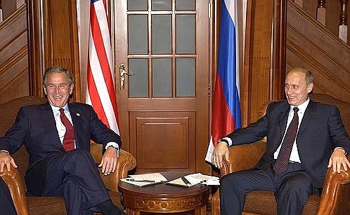 President Vladimir Putin in conversation with President George Bush of the United States.