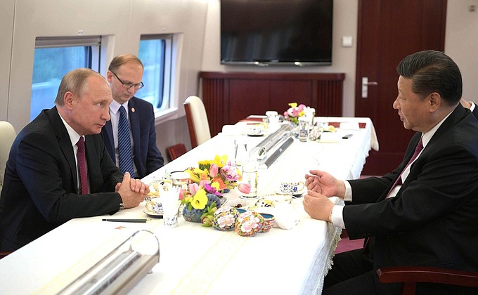 Vladimir Putin and President of China Xi Jinping travelling on a high-speed train.