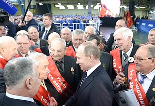 Vladimir Putin spoke briefly with veteran workers who took part in assembling the first truck at the plant.