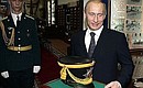 After visiting the museum, Vladimir Putin was presented with a shako, the hat that is part of the Presidential Regiment\'s ceremonial uniform.