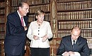 With Federal Chancellor of Germany Angela Merkel and President of France Jacques Chirac following the tripartite talks. Signing the book for Compiegne\'s guests of honour.