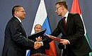 Signing ceremony for Russian-Hungarian documents. Russian Economic Development Minister Alexei Ulyukayev and Hungarian Minister of Foreign Affairs and Trade Peter Szijjarto sign an intergovernmental agreement on interregional cooperation.