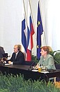 President Putin and Finnish President Tarja Halonen addressing a news conference.