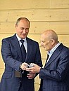 With judo coach Anatoly Rakhlin who turned 75 this year. A present from Vladimir Putin — a presidential watch with the number 75 on it.