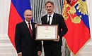 A letter of recognition for contribution to the development of Russia football and high athletic achievements is presented to Russia national football team coach Gintaras Stauce.