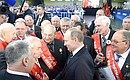 Vladimir Putin spoke briefly with veteran workers who took part in assembling the first truck at the plant.