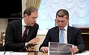 Minister of Industry and Trade Denis Manturov, left, and Minister of Labour and Social Protection Maxim Topilin before the meeting with Government members.